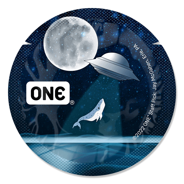 Circular sticker with 'ONE' logo, UFO, and whale illustration against a night sky with moon.