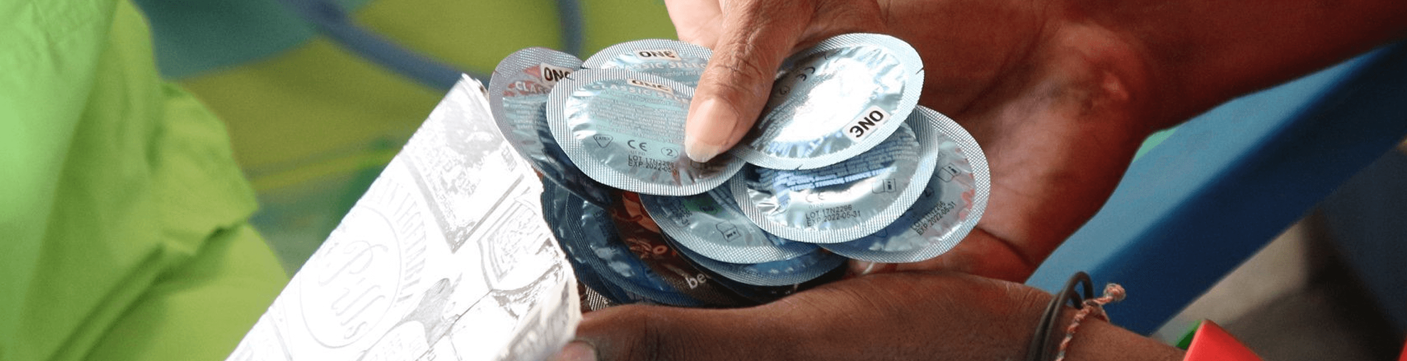 person putting condoms in a bag