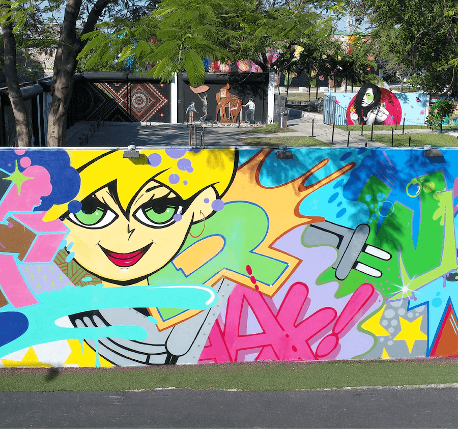 Colorful graffiti mural with a cartoon character on a wall.